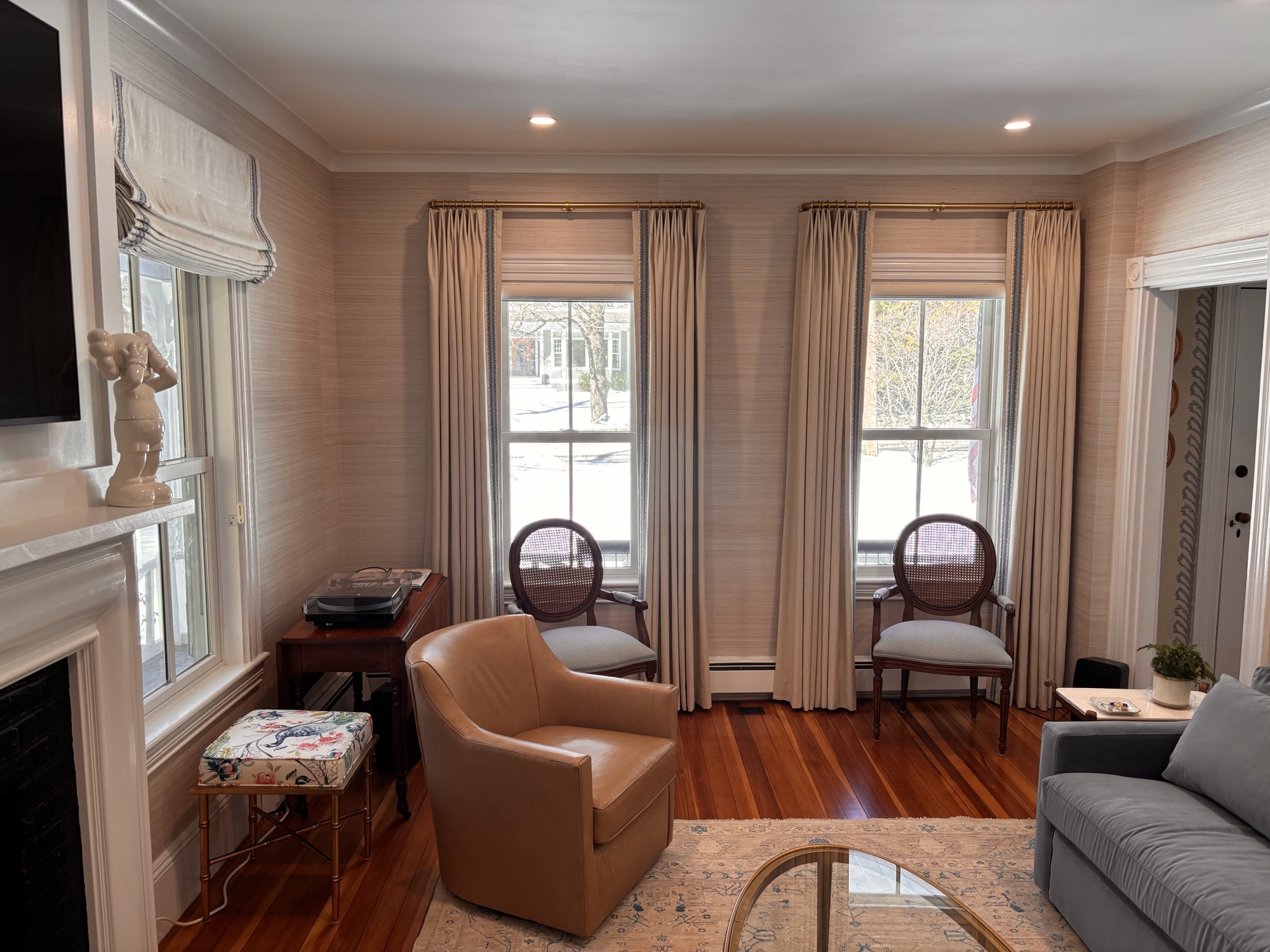 Designer measuring a window for custom shades in Waltham, MA